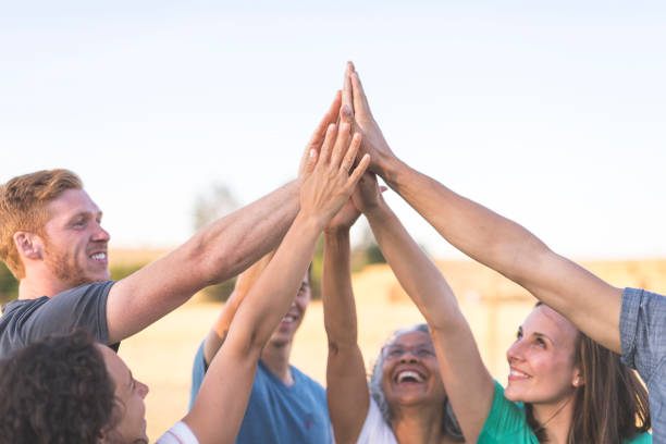 istock A cheerful group of adults high five 878581926