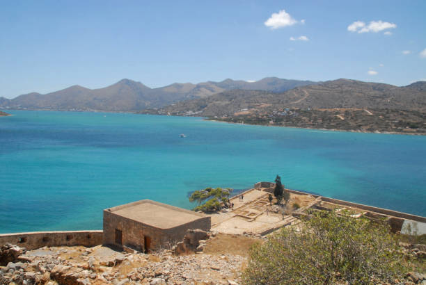 istock Turquoise sea surrounding Spinalonga Island 878596846