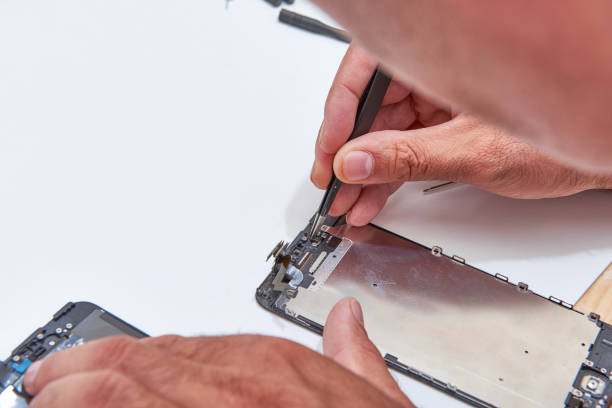 istock Technician Hand Repairing Cellphone,process of mobile phone repair, isolated on white background,Selective focus 878599072