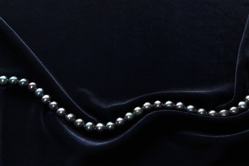 black pearl on dark blue velvet