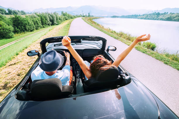 istock Couple in love ride in cabriolet car 878599762