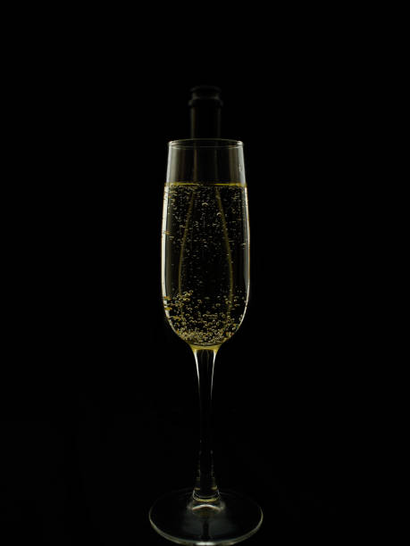 istock Stylish optical illusion, a bottle inside a glass with champagne. 878614556