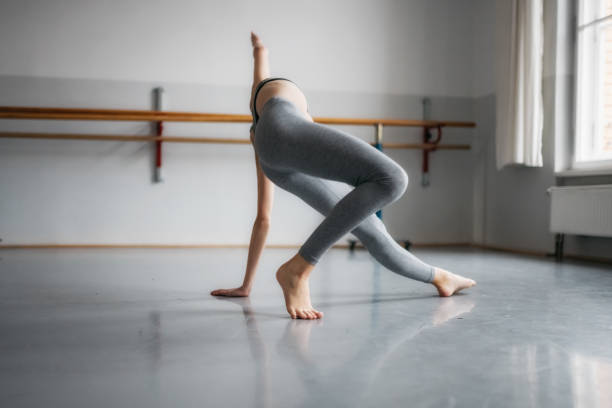 istock girl dancing ballett on floor in studio 878619834