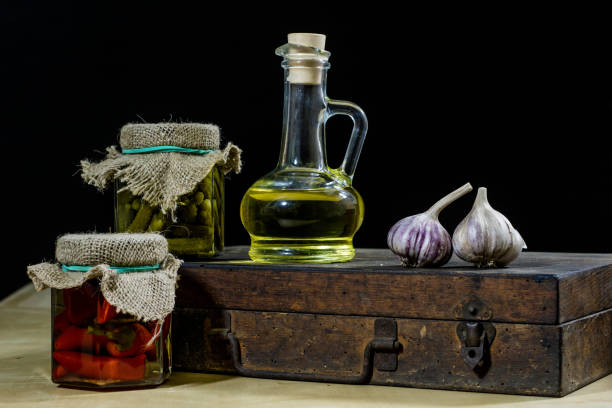Old books and spices. Dried garlic and recipes. Old kitchen table. Black background