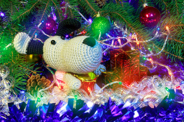 A festive 3D illustration featuring a decorated Christmas tree with colorful ornaments, string lights, snow elements, and gift boxes.