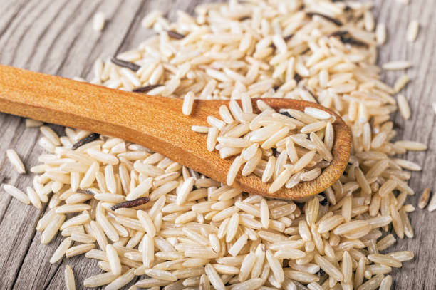 istock Mixed dry rice in a wooden spoon 878636306
