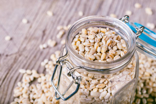 istock Pearl barley grains in a glass jar 878636414