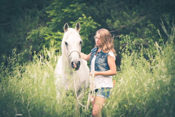 istock Girl and White Horse 878636572
