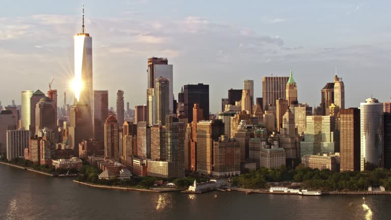 Aerial shot of the Lower Manhattan with the Freedom Tower reflecting the sunlight. Shot in NYC, USA.