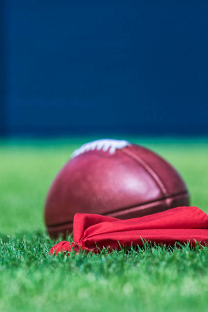istock Coach's red Challenge Flag with Pro American football on grass 878650500