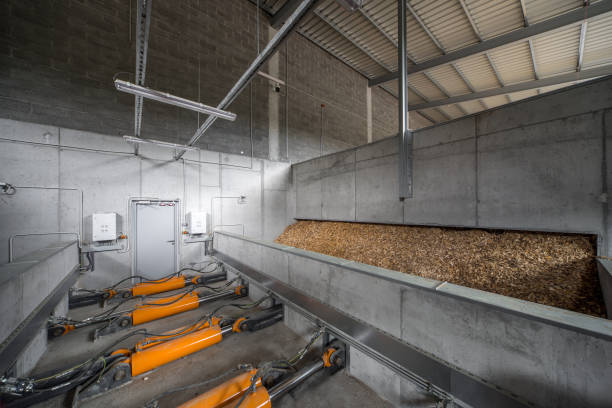 istock Modern boiler house. The hydraulic system supplying wood chips. Fuel supply. 878659442