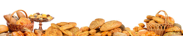 Panorama of fresh bread products Panorama of fresh bread products isolated on white background. wide cake stock pictures, royalty-free photos & images