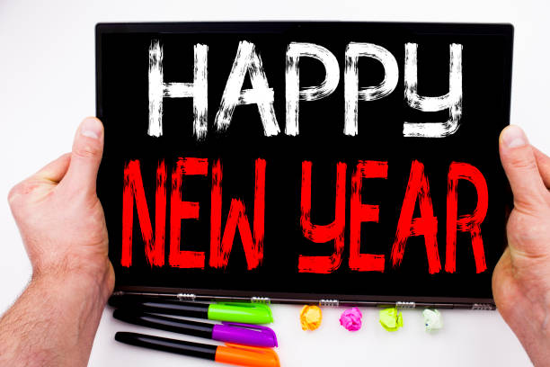 istock Happy New Year text written on tablet, computer in the office with marker, pen, stationery. Business concept for Christmas Celebration white background with copy space 878662800