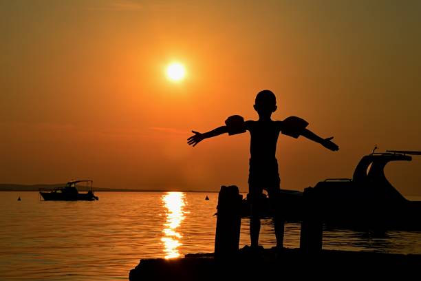 Free picture: A silhouette of a person in a small motorboat on a lake ...