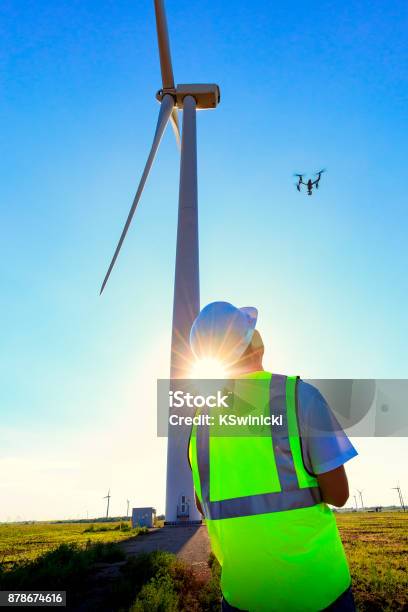 Drone Pilot Operating Uav During Wind Turbine Inspection Stock Photo - Download Image Now