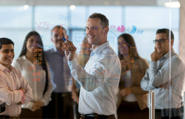 istock Man making a presentation in a business meeting at the office 878674740