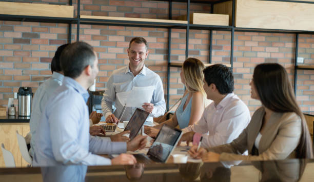 istock Happy man talking in a business meeting 878674748