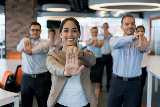 istock Group of business people stretching while taking a break from work at the office 878674764