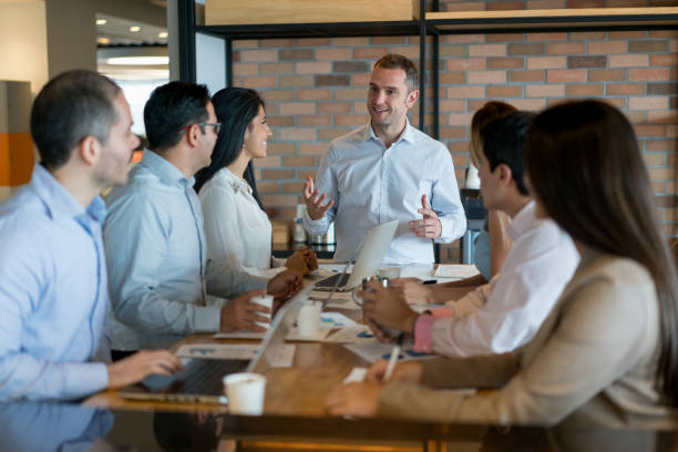 istock Successful man talking in a business meeting 878674932