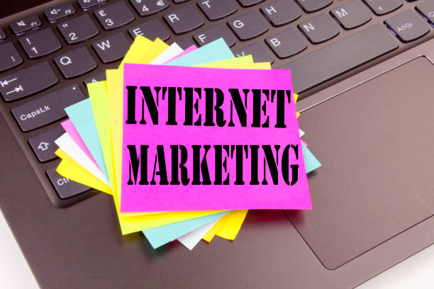 istock Writing Internet Marketing text made in the office close-up on laptop computer keyboard. Business concept for Technology Strategy Design Workshop on the black background with copy space 878676250