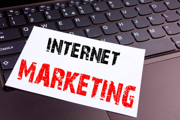 istock Writing Internet Marketing text made in the office close-up on laptop computer keyboard. Business concept for Technology Strategy Design Workshop on the black background with copy space 878677018