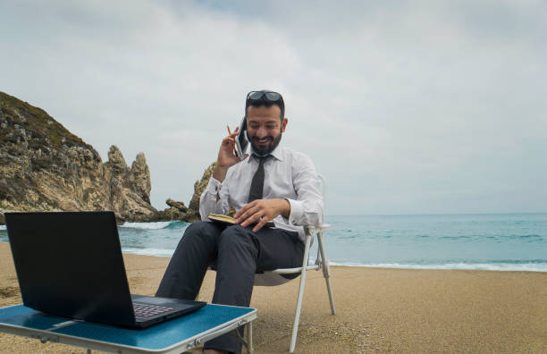 istock Businessman on the Beach - Work Follow 878686800