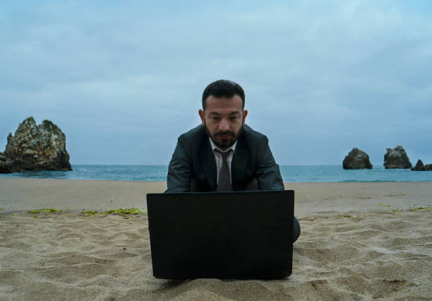 istock Businessman on the Beach - Work Follow 878686848