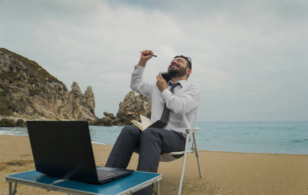 istock Businessman on the Beach - Work Follow 878686852