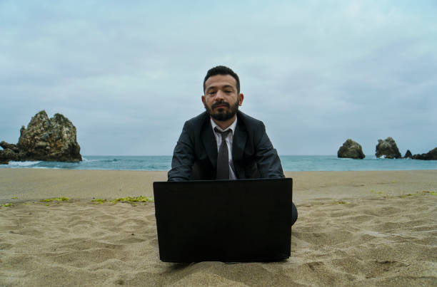 istock Businessman on the Beach - Work Follow 878686858