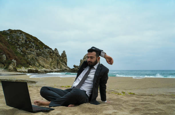 istock Businessman on the Beach - Work Follow 878686892