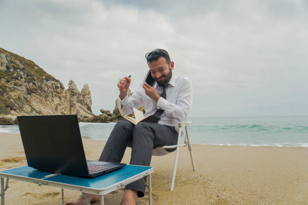 istock Businessman on the Beach - Work Follow 878686894