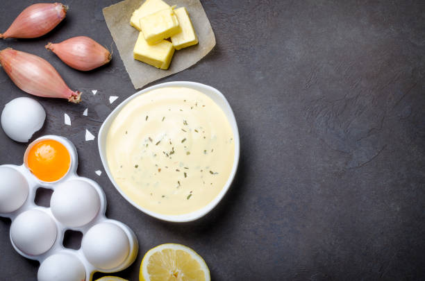 istock Basic french sauce bearnaise in a white bowl with ingredients, b 878689098
