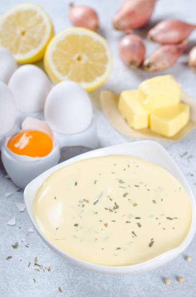 istock Basic french sauce bearnaise in a white bowl with ingredients, b 878689282