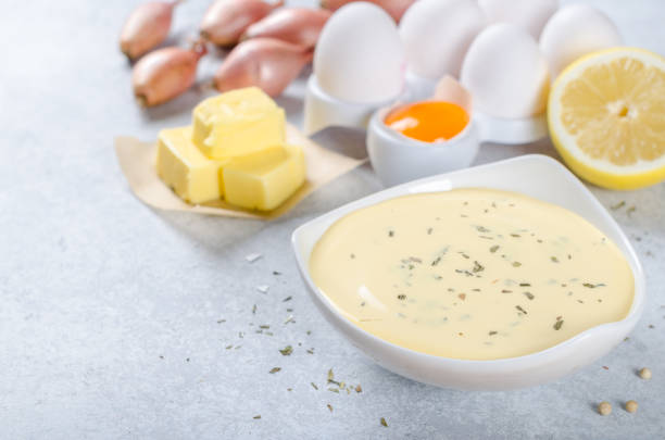 istock Basic french sauce bearnaise in a white bowl with ingredients, b 878689332