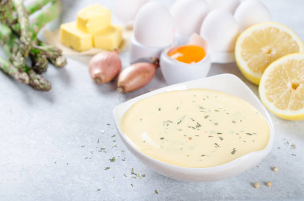istock Basic french sauce bearnaise in a white bowl with ingredients, b 878689360