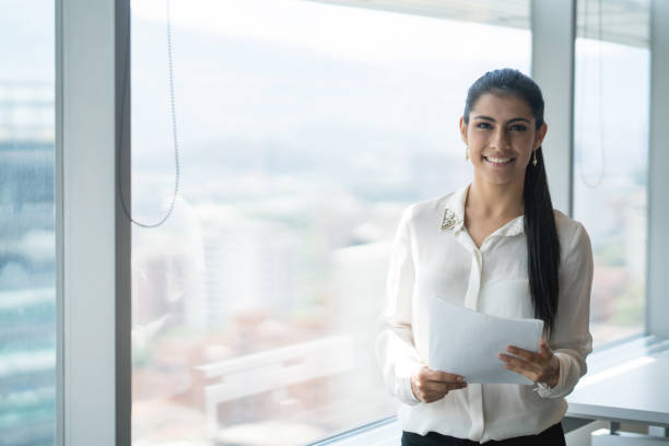 istock Business woman working at an office with a view 878692190