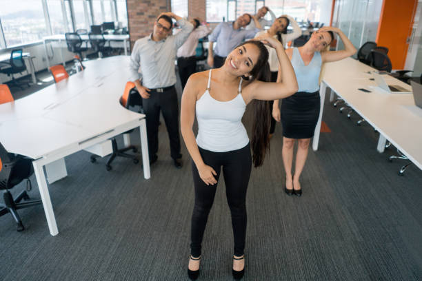 istock Business people stretching while taking a break from work at the office 878692196