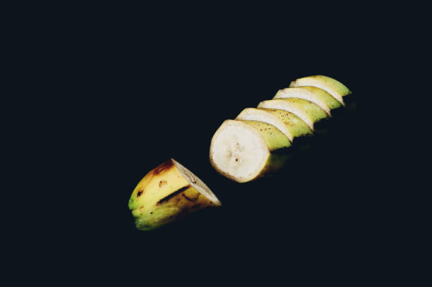 istock Sliced banana on a black background 878692672