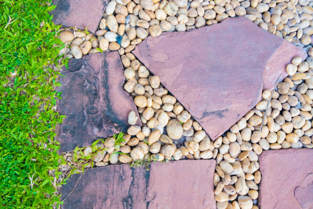 istock Green grass field with stone pathway and small rock decoration. 878702410