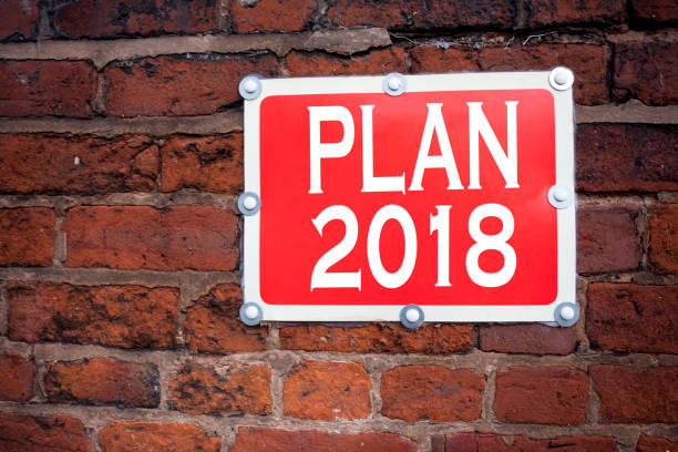 istock Hand writing text caption inspiration showing Plan 2018 concept meaning Strategy Action Plan 2018 written on old announcement road sign with background and copy space 878705872