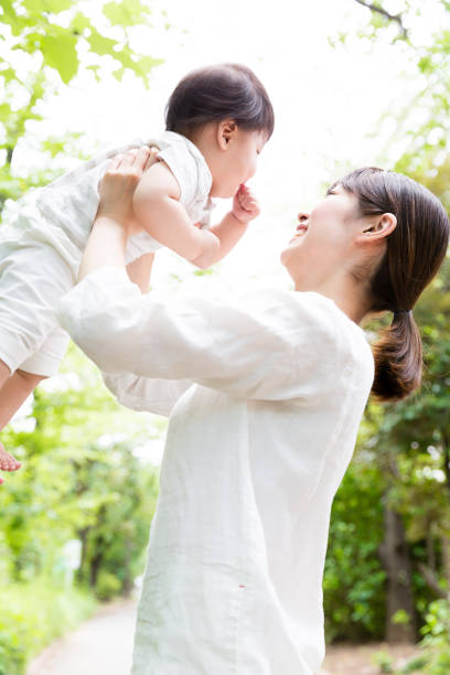 istock asian mother and baby in park 878706242