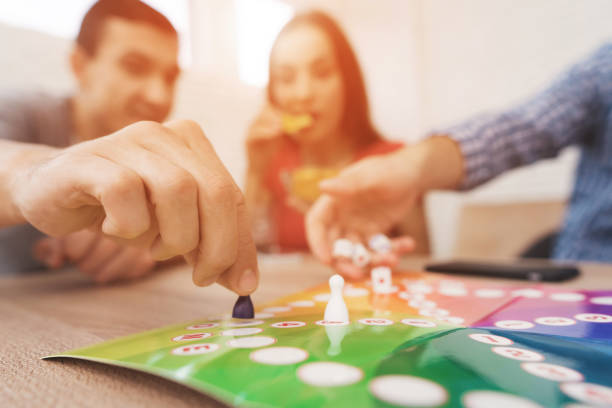 若い人たちは、サイコロとチップを使用してボード ゲームをプレイします。 - board game success victory winning ストックフォトと画像
