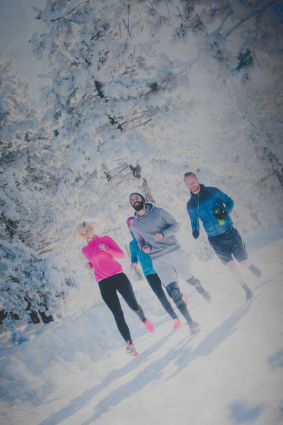 istock Four people running on snowy mountain 878717088