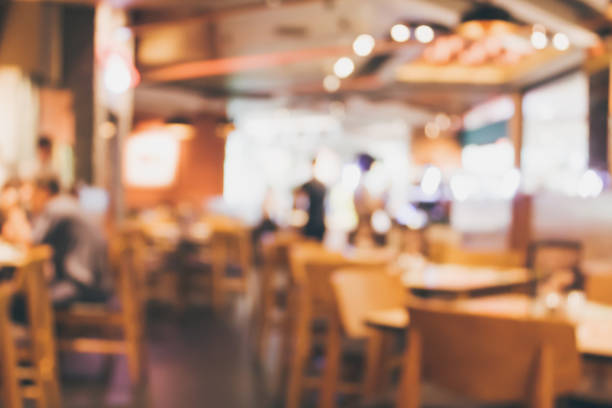 istock Restaurant cafe or coffee shop interior with people abstract blur background 878717114