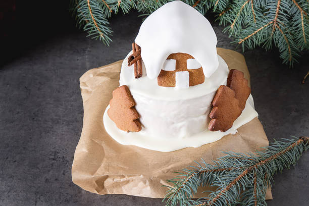 New Year cake with Christmas trees and gingerbread houses and cinnamon. Dark background.