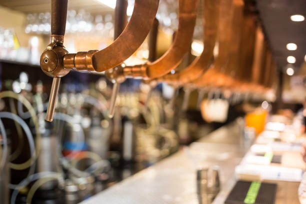 istock Beer bar pub tap, counter with blur pub background. Brussel Belgium 878721098