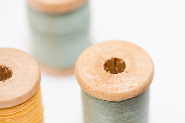 istock Bobbins of thread isolated on white background 878721428