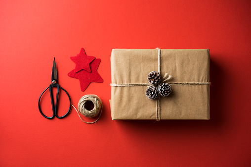 Christmas gift box flat lay on red background