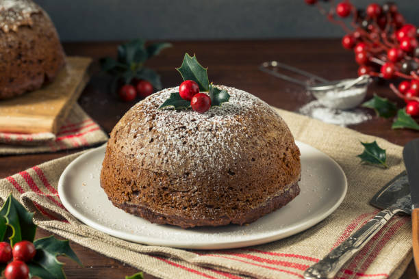 Sweet Homemade Christmas Figgy Pudding Sweet Homemade Christmas Figgy Pudding with Powdered Sugar christmas cake stock pictures, royalty-free photos & images