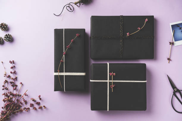 istock Black gift box flat lay on purple background 878727698